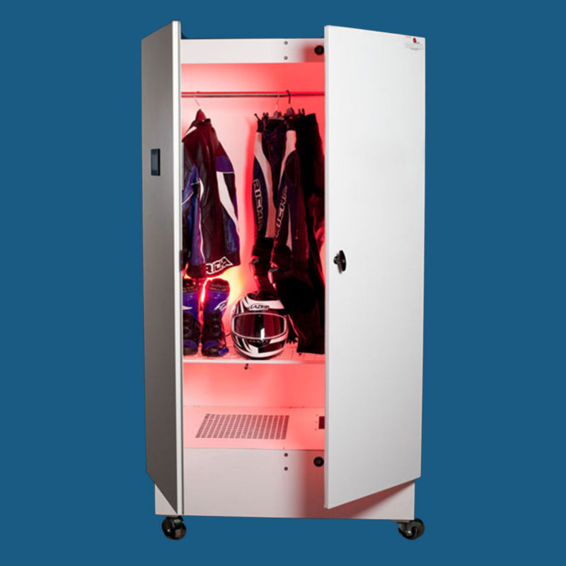 White Ozone cabinet with doors open and pink light inside displaying motorcycle suit and helmet.