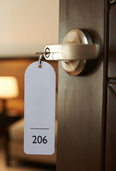 The door to a warm-coloured hotel room opens when the key is inserted.