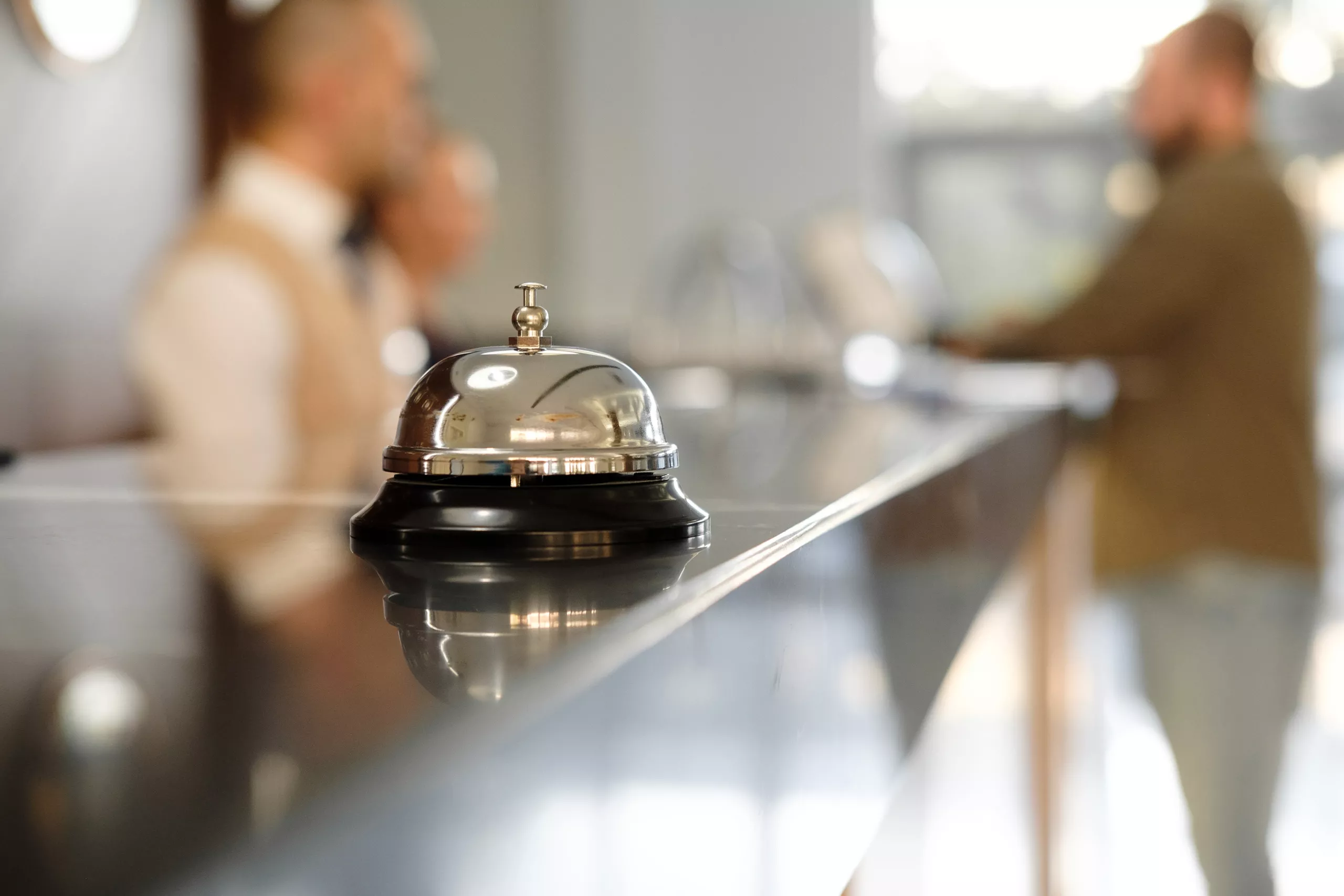 Hotel cleaning 2 Close up of silver bell on hotel reception desk.